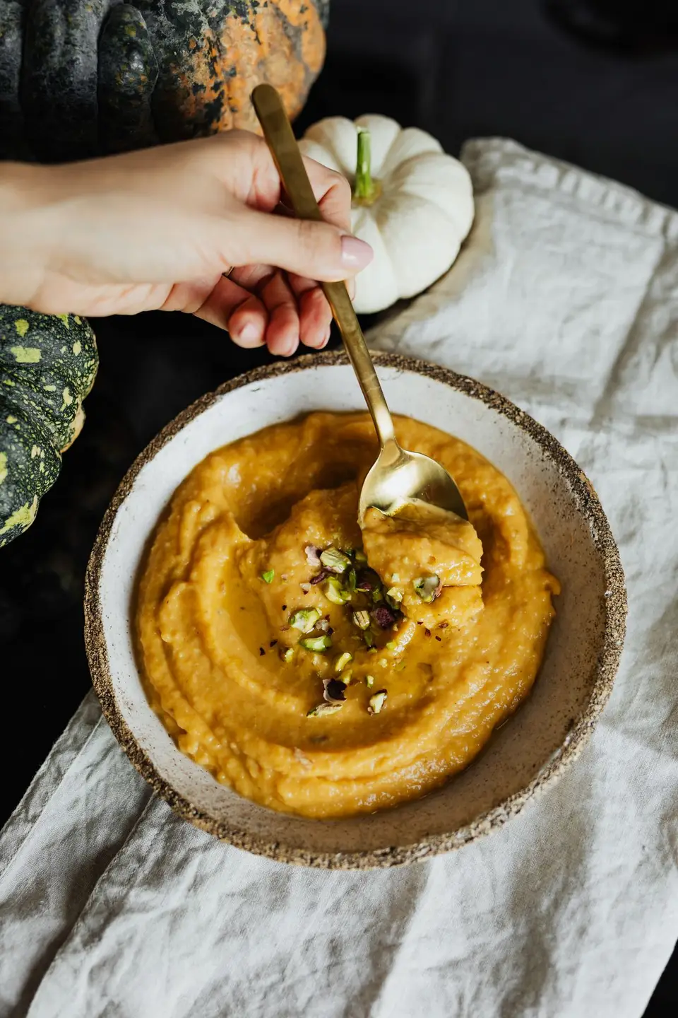 Miska z puree z dyni udekorowana orzechami